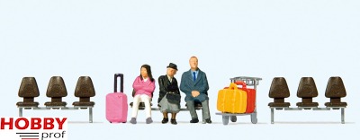 Three Waiting Travellers with Luggage Trolley with Seats